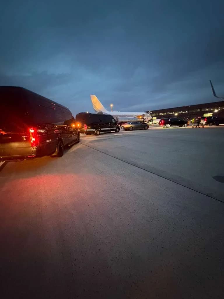 Group of travelers boarding a luxury airport transportation vehicle
