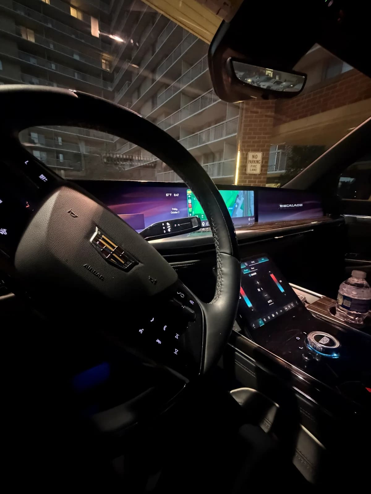 Dashboard view inside an AZA Cadillac Escalade at night
