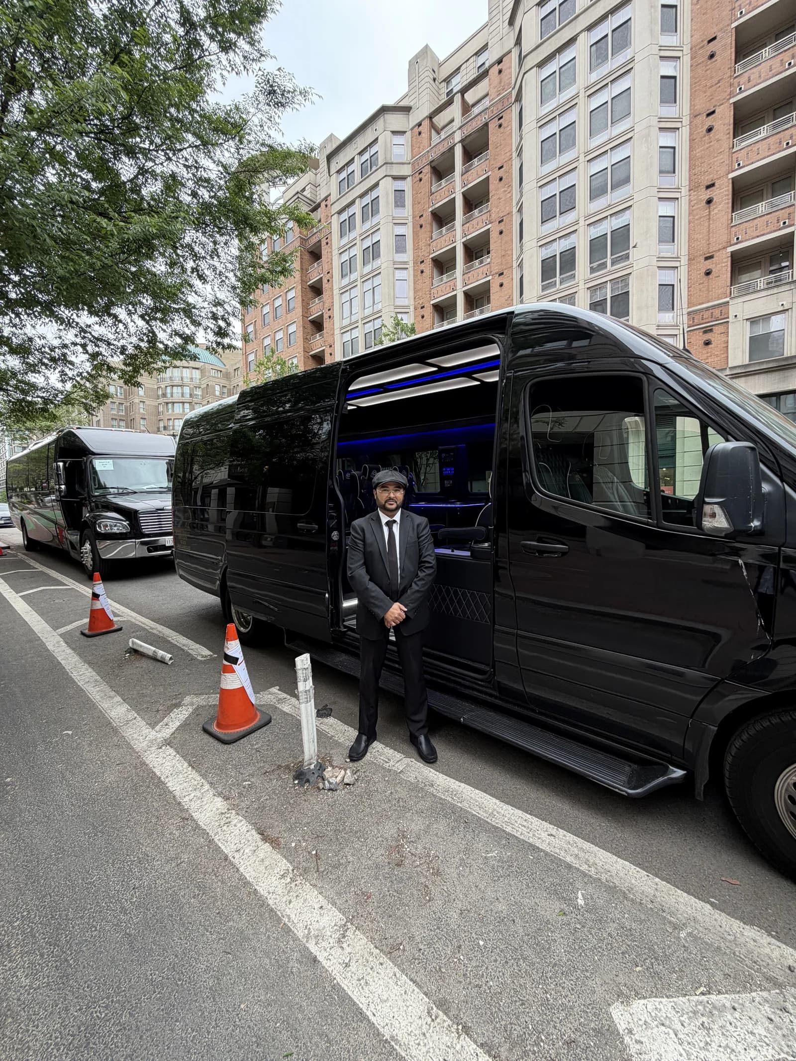 AZA chauffeur beside a Sprinter van on a Washington DC to New York City charter route