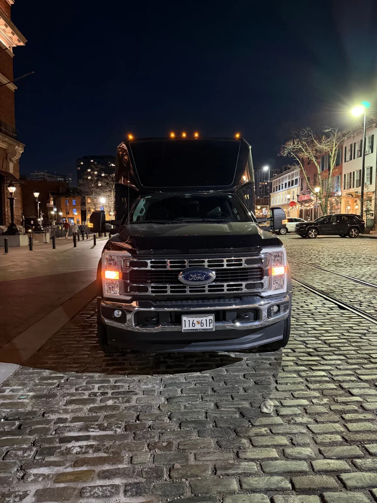 AZA Mini Party Bus front grille at night