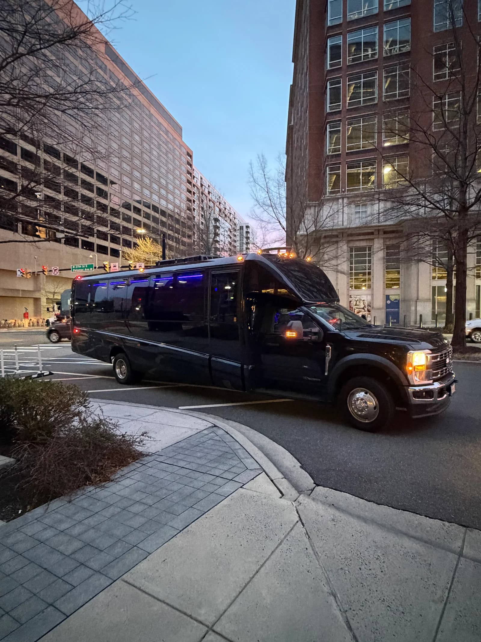 AZA black executive bus on the move in DC