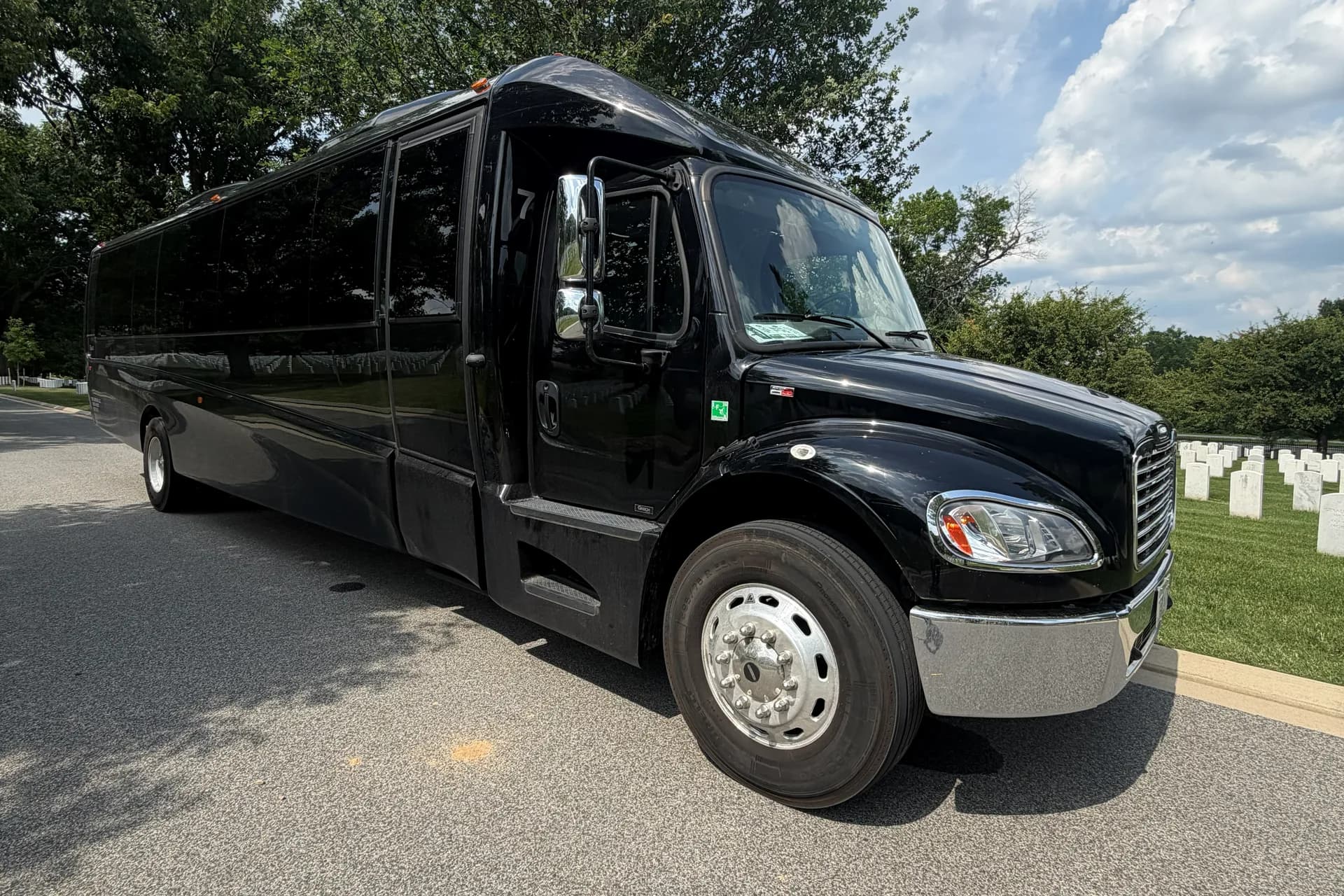 AZA GM40 black bus parked, front three-quarter exterior view