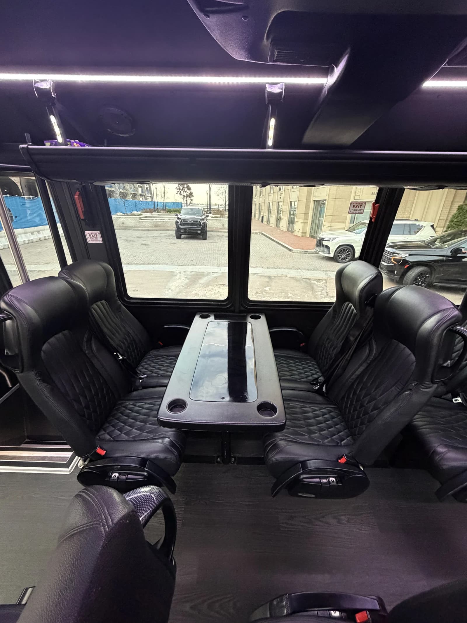 Captain's chairs and table inside the GM40 bus, sized for small and large weddings