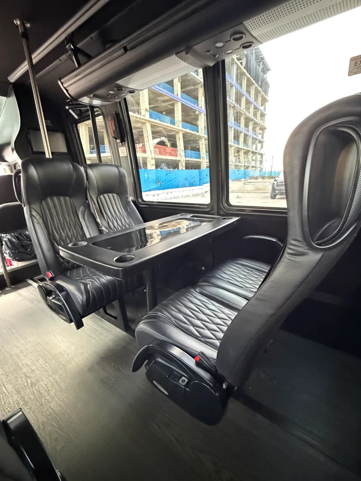 Captain's chairs beside a window inside the AZA GM40 bus