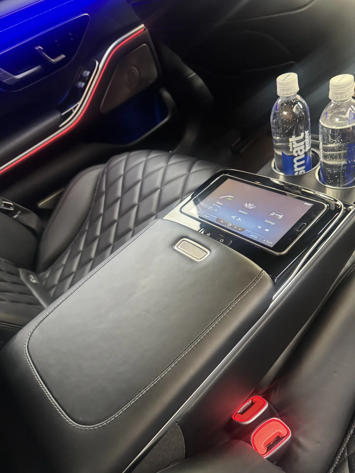 Rear armrest touchscreen and bottled water in the S-Class