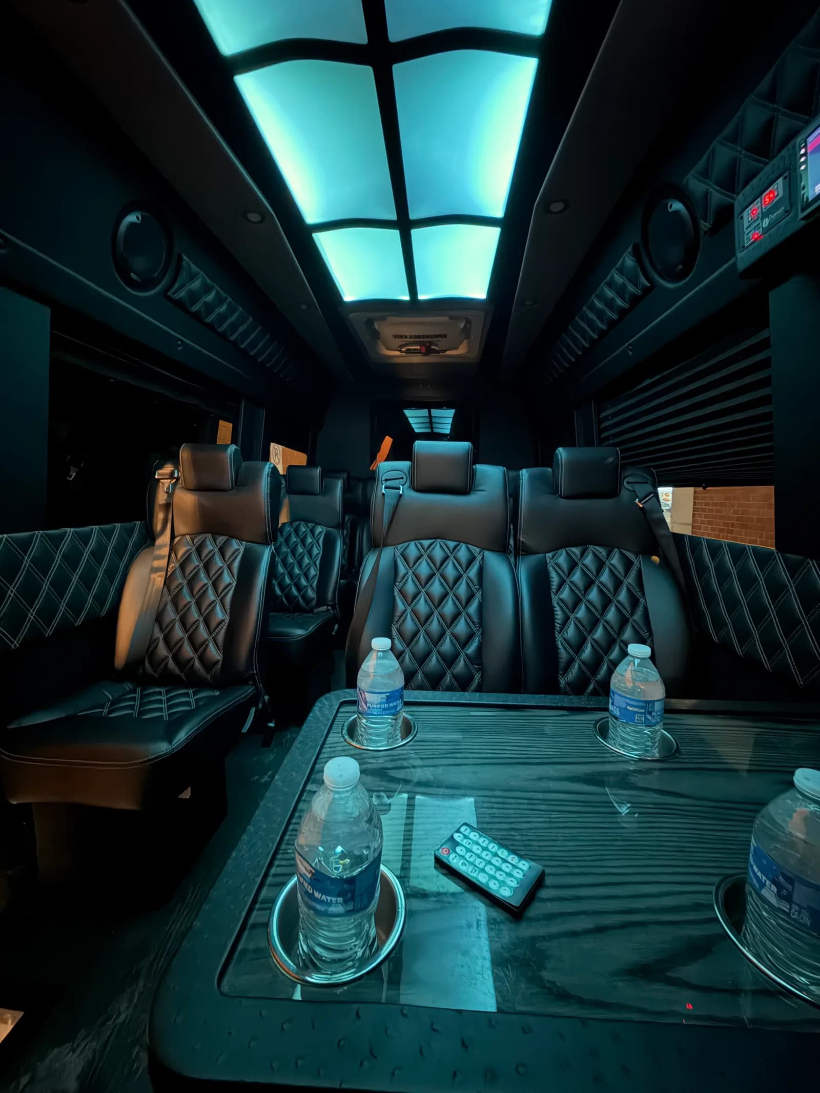 AZA Sprinter van interior with bottled water, ready for group transportation