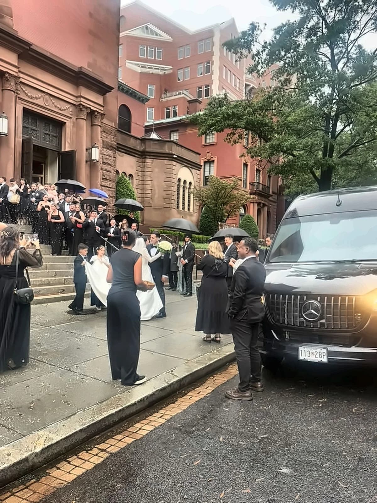 AZA Mercedes van outside a church as the wedding party exits